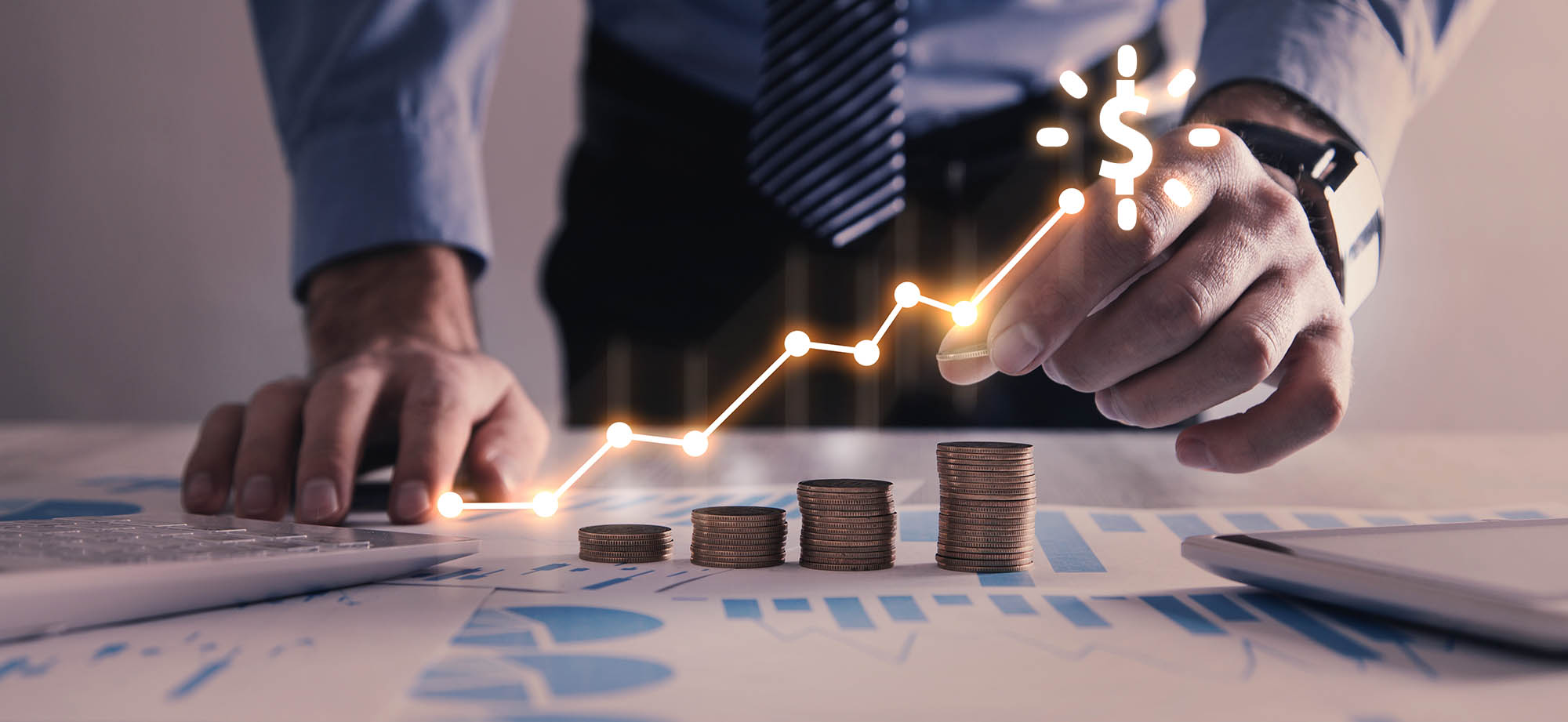 Man stacking coins with a graph of profit.